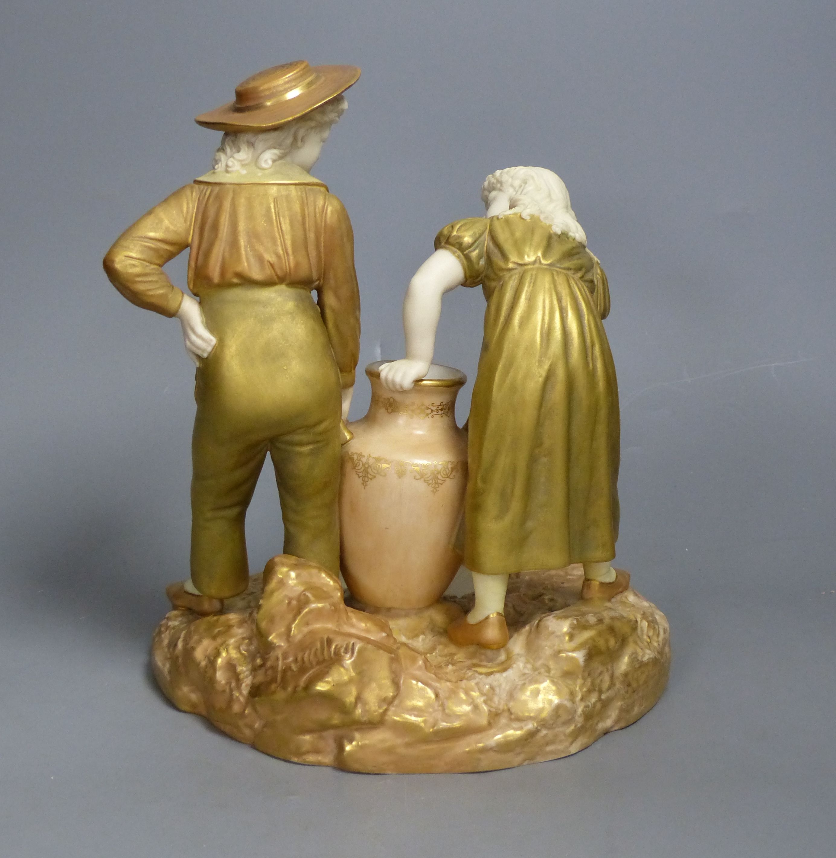 A Royal Worcester group of a boy and a girl, date code for 1917, height 24cm